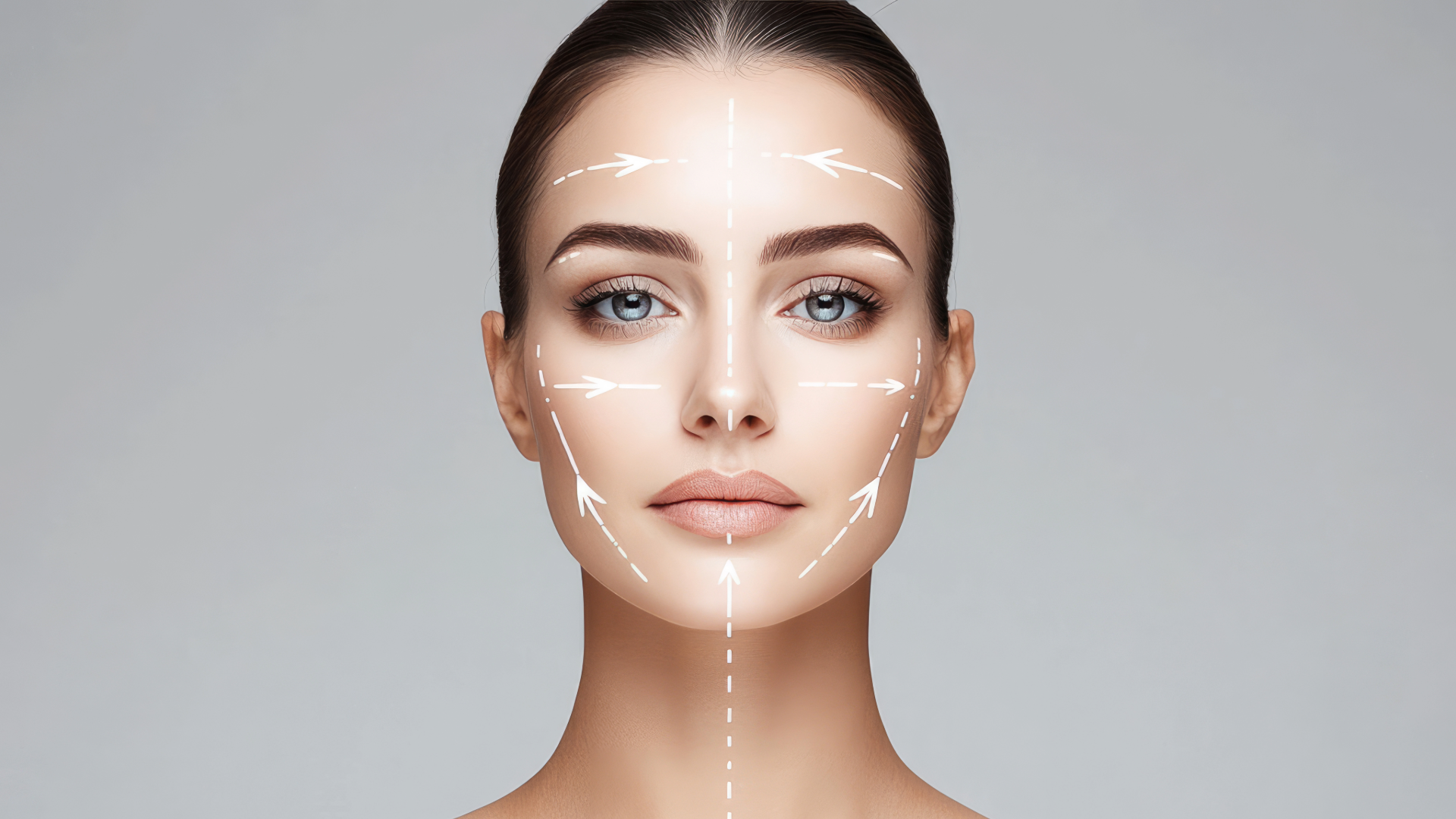 Face with white surgical markings outlining brows, cheeks, and jawline for cosmetic procedure planning